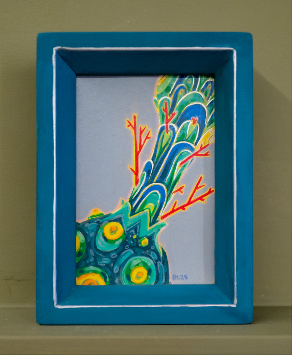 Small acrylic painting of a blue-green plume of scales rising from a bumpy teal base with yellow spots and red branches, in a handmade teal frame.