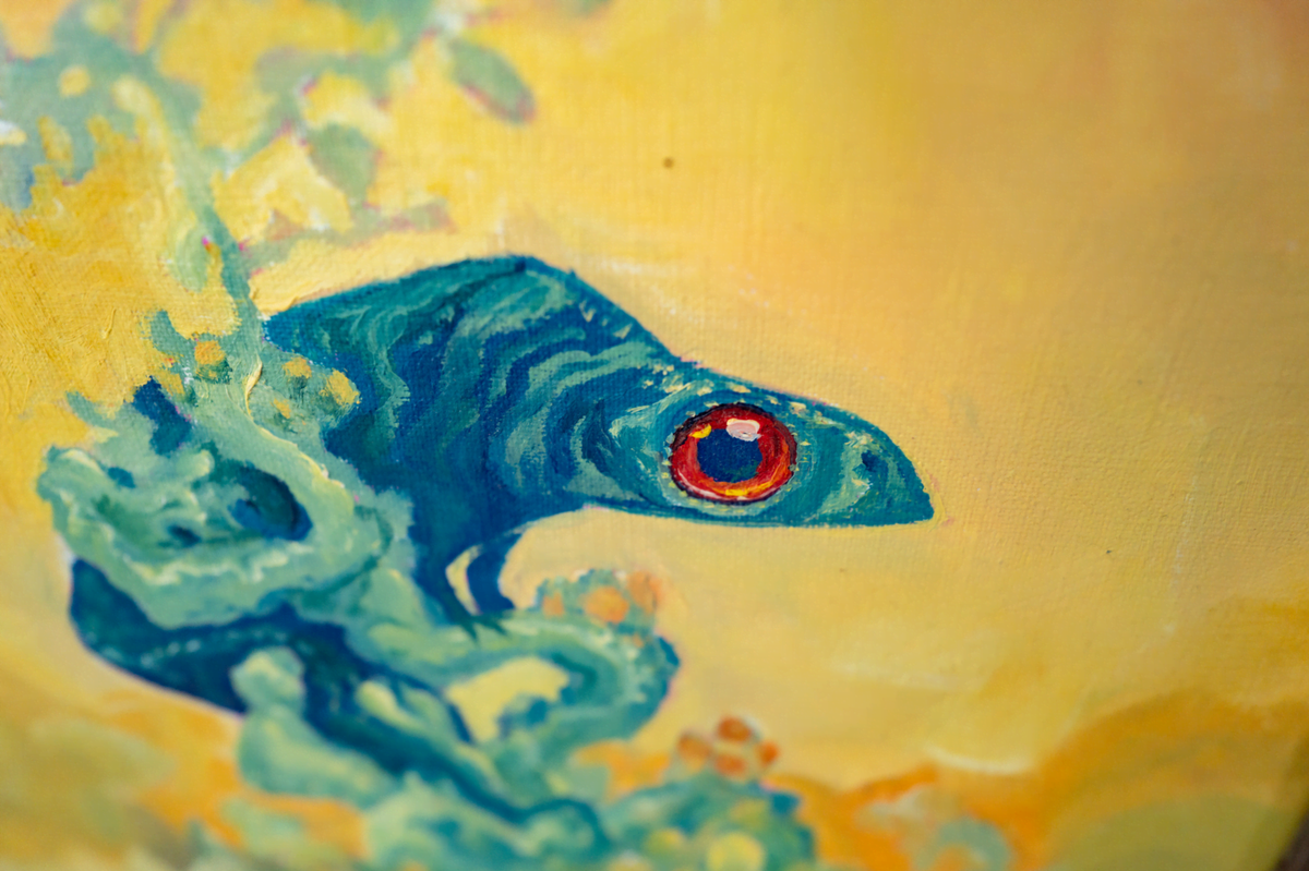 Close-up of the Ocotillo painting showing the lizard's red eye and the texture of the oil brushstrokes.